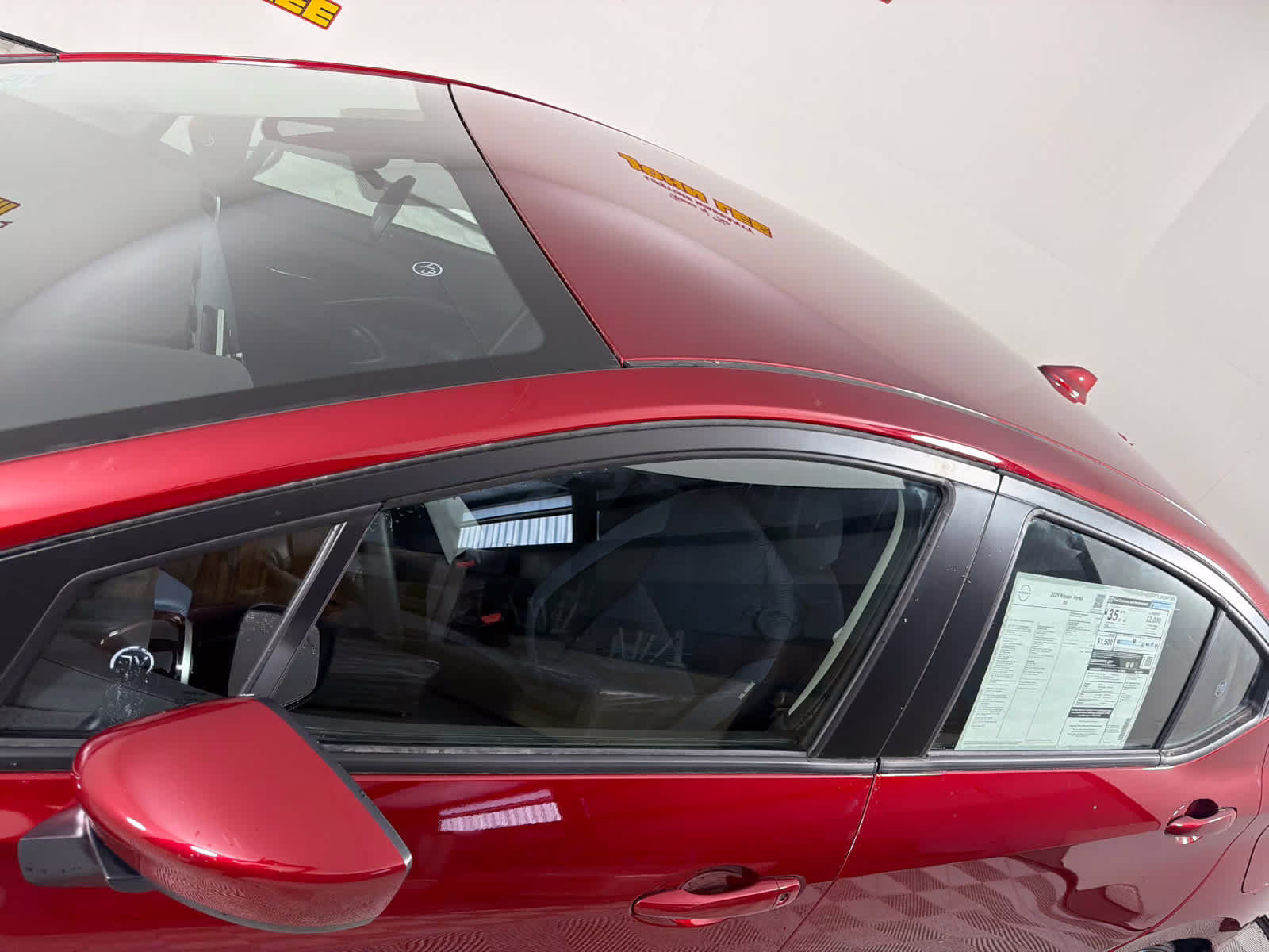 2025 Scarlet Ember Tintcoat Nissan Versa SV FWD Sedan