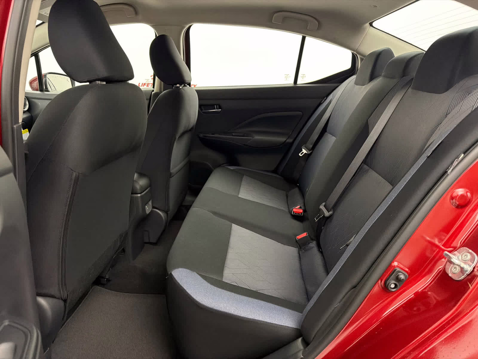 2025 Scarlet Ember Tintcoat Nissan Versa SV FWD Sedan