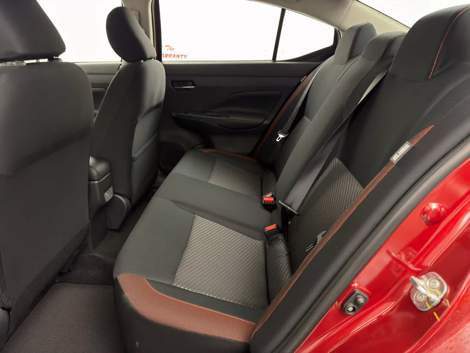 2025 Scarlet Ember Tintcoat Nissan Versa SR FWD Sedan