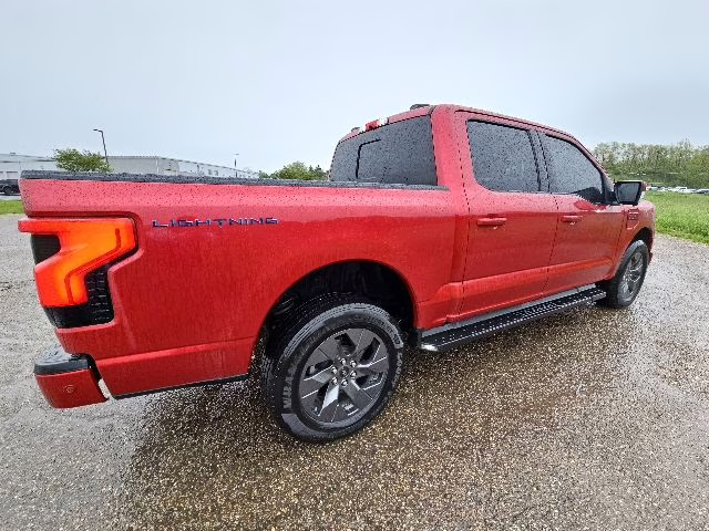 2023 Rapid Red Metallic Tinted Clearcoat Ford F-150 Lightning Lariat AWD Truck