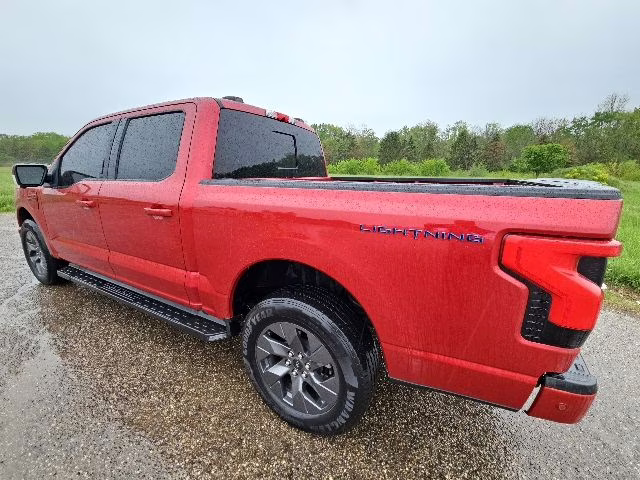 2023 Rapid Red Metallic Tinted Clearcoat Ford F-150 Lightning Lariat AWD Truck