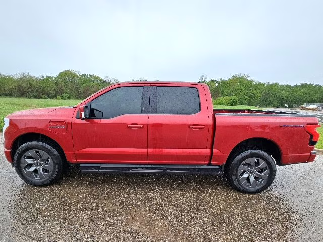 2023 Rapid Red Metallic Tinted Clearcoat Ford F-150 Lightning Lariat AWD Truck