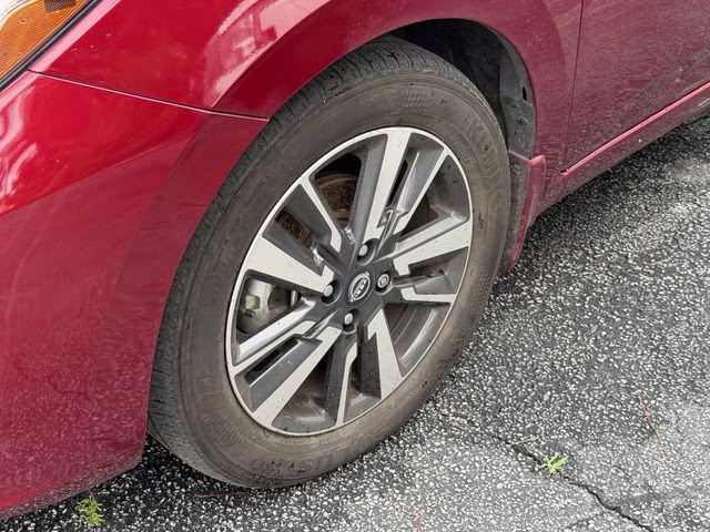 2024 Scarlet Ember Tintcoat Nissan Versa 1.6 SV FWD Sedan