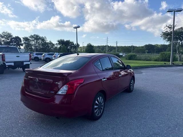 2014 Red Brick Nissan Versa SV FWD Sedan
